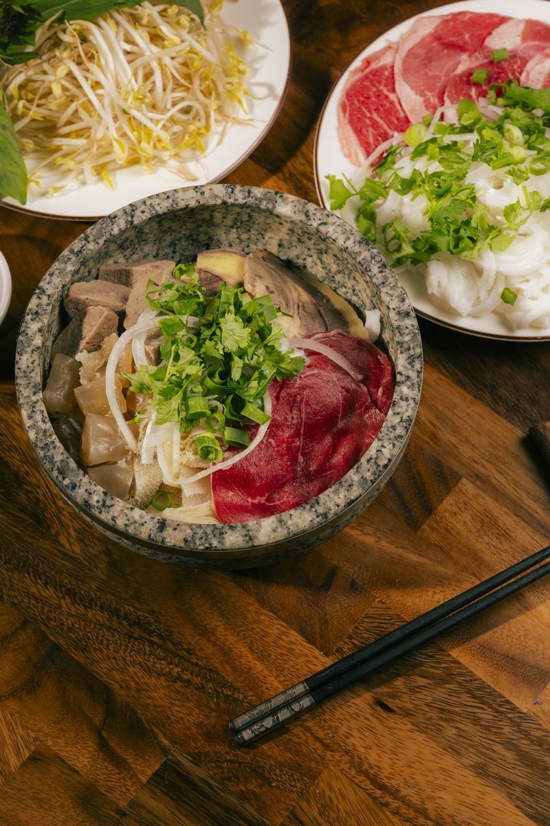Phở Thố Đá — signature stone bowl beef pho with rare beef and fresh herbs