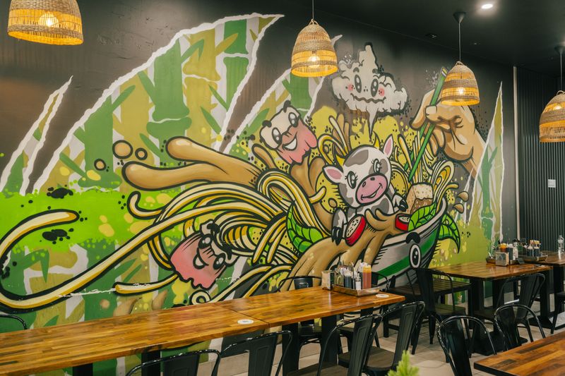 The Vietnamese food mural on the dining room wall at Bà Năm