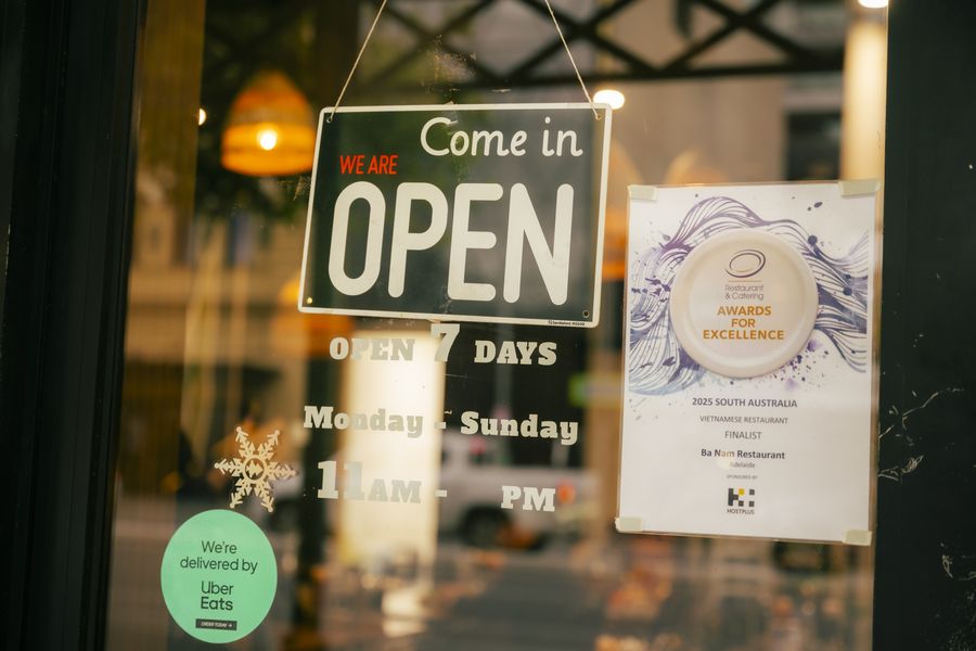 Bà Năm front door with the Open 7 days sign and the 2025 SA Restaurant & Catering Awards finalist certificate
